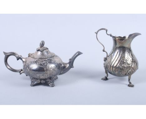 A Victorian silver cream jug with embossed floral sprays, on pad feet, 6oz troy approx, and a silver plated teapot 