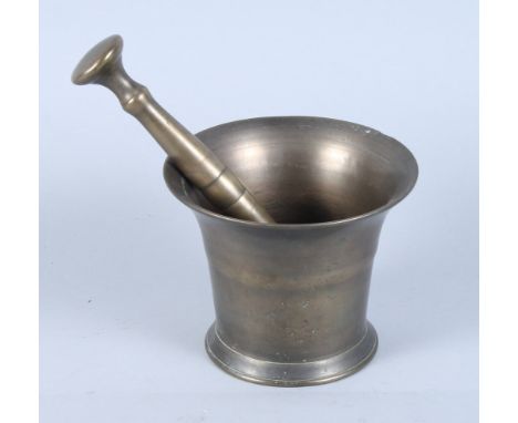 An 18th century bronze pestle and mortar, 4 1/2" high, and a 19th century brass preserve pan with strap handle, 13 1/2" dia 