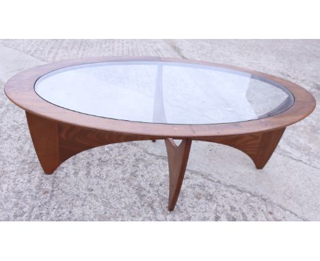 A mid 20th century Ercol mahogany and glass inset oval coffee table, on stylised supports, 48" wide 