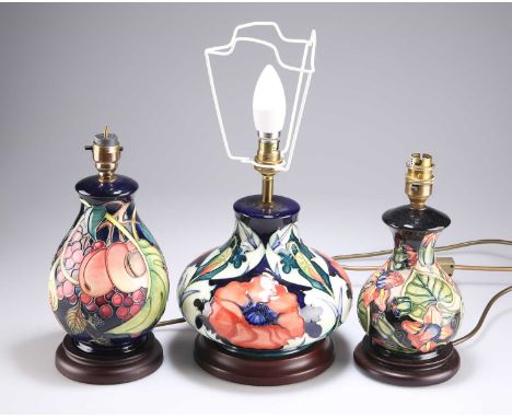 THREE MODERN MOORCROFT POTTERY TABLE LAMPS the largest of squat baluster form, 'Anemone' pattern; another in the 'Fig, Grape 