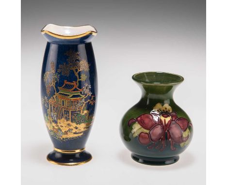 A WILLIAM MOORCOFT 'COLUMBINE' PATTERN POTTERY VASE, AND A WILTSHAW AND ROBINSON CARLTON WARE VASE the Moorcroft vase of balu