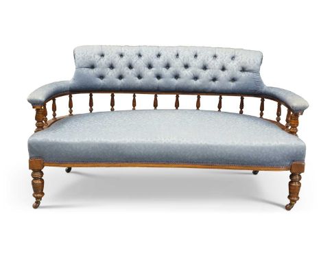 A VICTORIAN MAHOGANY AND UPHOLSTERED SETTEE, LATE 19TH CENTURY with button-back and stuffed-over arms, raised on ring-turned 