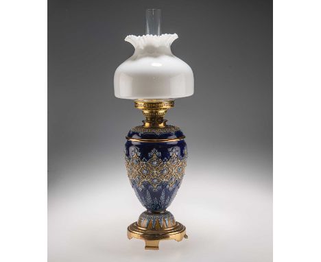 A LATE 19TH CENTURY DOULTON LAMBETH STONEWARE OIL LAMP the ovoid body raised on a domed circular foot to a brass stand on bra