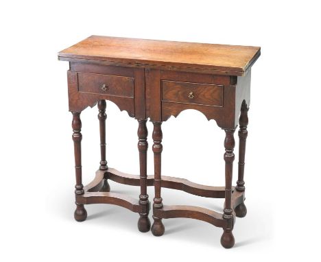 AN EARLY 18TH CENTURY OAK FOLDOVER WRITING TABLE with two drawers and gateleg action, raised on ring-turned and baluster legs