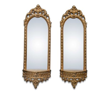 A PAIR OF PERIOD STYLE GILT-COMPOSITION PIER MIRRORS modern, each with an openwork leaf-moulded crest and demilune shelf base