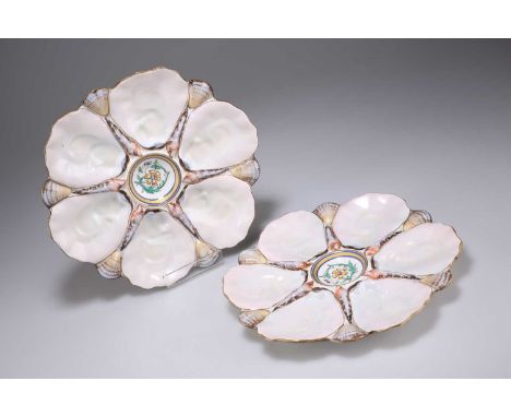 A PAIR OF EARLY 20TH CENTURY CONTINENTAL PORCELAIN OYSTER DISHES each with six 'oyster shell' receivers spaced by decorative 