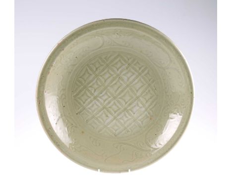 A CHINESE LARGE CELADON CHARGER the well decorated with a diaper pattern within a foliate scroll border. 42cm diameterVarious
