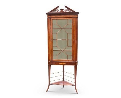 A SHERATON REVIVAL INLAID MAHOGANY CORNER CABINET ON STAND, 19TH CENTURY with fretwork broken pediment, the glazed door enclo