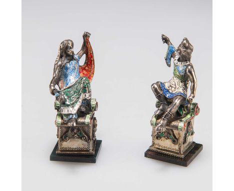 A PAIR OF CONTINENTAL SILVER AND ENAMEL FIGURES, 19TH CENTURY French import marks, each modelled seated on a rolled carpet up