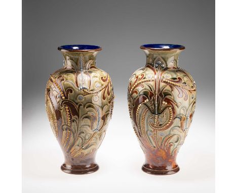 FRANK A. BUTLER FOR DOULTON LAMBETH, A LARGE PAIR OF LATE 19TH CENTURY STONEWARE VASES of baluster form with flared necks, de
