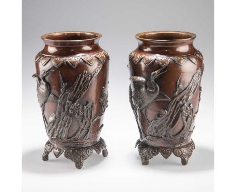A PAIR OF JAPANESE BRONZE VASES, MEIJI PERIOD each decorated with boldly cast cranes and prunus, raised on an integral 'stand