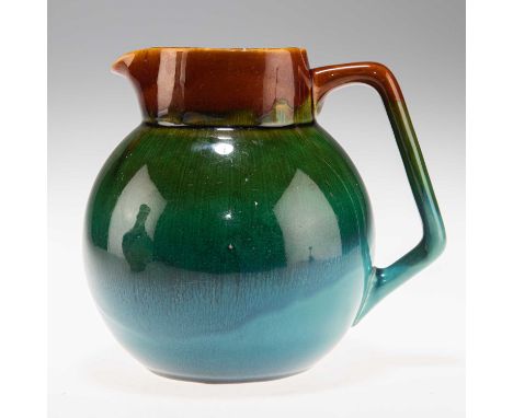 CHRISTOPHER DRESSER (1834-1904) FOR LINTHORPE POTTERY, AN ART POTTERY JUG globular form with angular handle, glazed in gradua