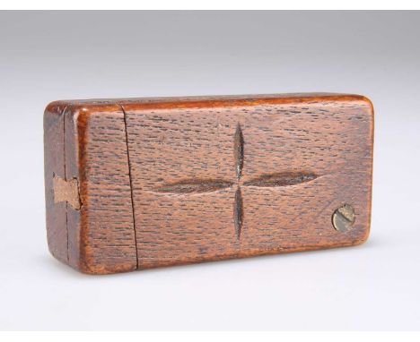 A 19TH CENTURY TREEN PUZZLE SNUFF BOX rectangular, the cover centred by a carved motif. 7.6cm wide