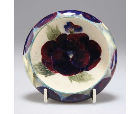 A WILLIAM MOORCROFT  BURSLEM 'PANSY' PATTERN POTTERY TRINKET DISH squat form with everted rim, tubelined and hand-painted in 