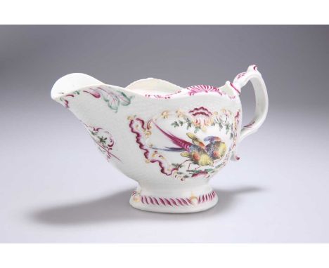 A WORCESTER FIRST PERIOD POLYCHROME SAUCEBOAT, CIRCA 1765 painted with exotic birds within C-scroll parcel gilt moulded carto
