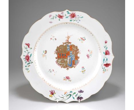 A CHINESE ARMORIAL PORCELAIN DISH, QIANLONG, CIRCA 1755 shaped circular with a bold armorial, painted in Famille Rose enamels