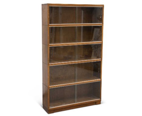 A MINTY OAK STACKING BOOKCASE each of the five sections with sliding glass doors, labelled. 153.5cm high, 89.5cm wide, 23cm d