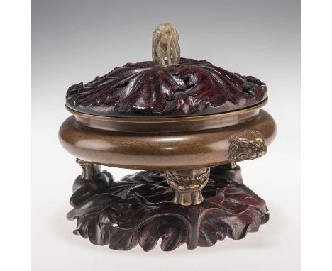 A CHINESE JADE AND BRONZE TRIPOD CENSER circular, the pierced and leaf-carved cover surmounted by a pierced jade carving of c