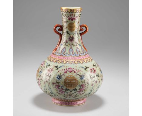 A CHINESE FAMILLE ROSE ENAMEL VASE the squat body with twin loop handles to the neck, enamel decorated in the typical palette