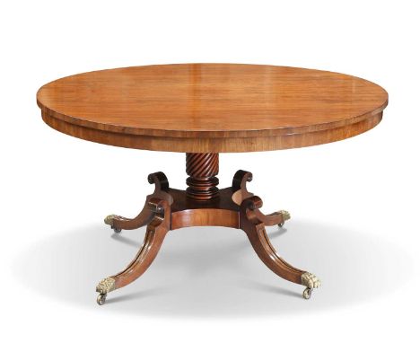 A REGENCY MAHOGANY TILT-TOP BREAKFAST TABLE the circular top raised on a ring-turned and wrythen cylinder pedestal, supported