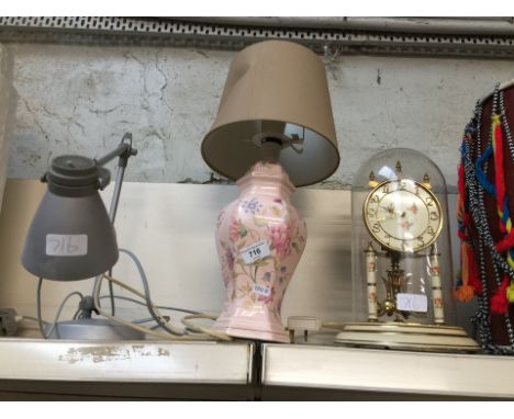 Two lamps and a revolving pendulum clock 
