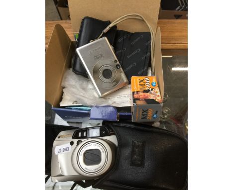 A Canon powershot digital camera and a Pentax camera 
