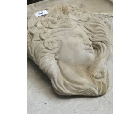 A wall hanging planter in the shape of a lady 