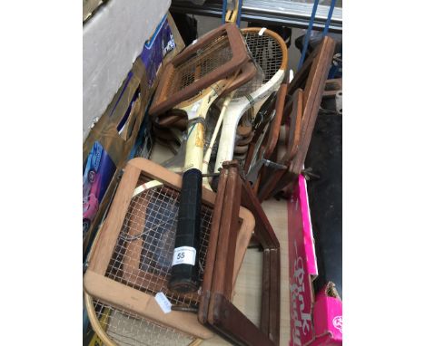 A group of vintage tennis rackets and clamps 