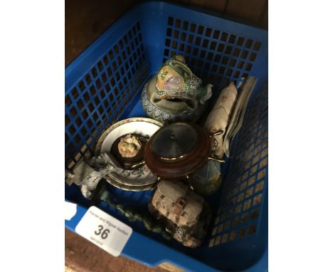 A box of misc ornaments including mini ships wheel barometer and a Doulton stoneware ashtray. 