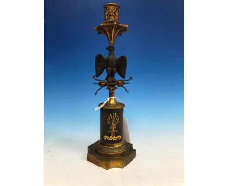 A 19th C. FRENCH PARCEL GILT BRONZE CANDLESTICK, THE NOZZLE SUPPORTED ON A SPREAD EAGLE PERCHED ON LIGHTENING ABOVE A SOCLE, 