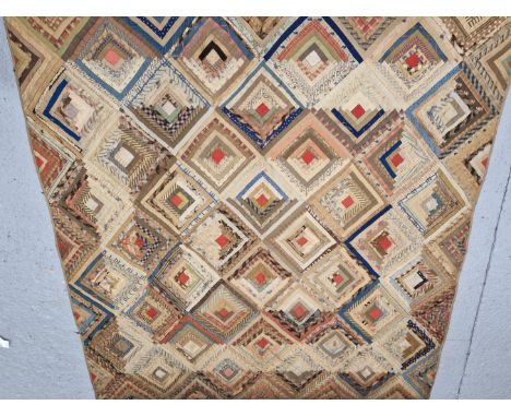A DIAMOND DIAPER PATTERN QUILTED TEXTILE PANEL OR CURTAIN LINED IN RED AND WITH WOODEN RINGS SEWN INTO ONE NARROW END.   183 