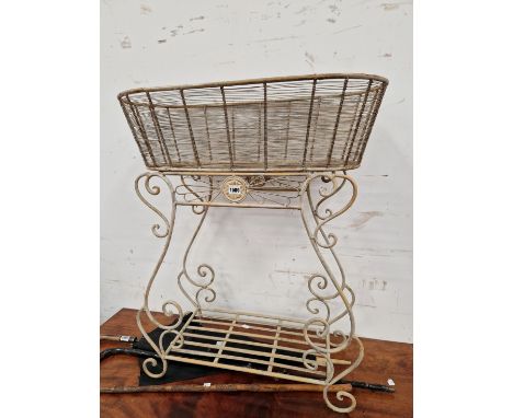 A WIRE WORK PLANTER TABLE WITH A SLATTED SHELF ABOVE THE SCROLLING FEET