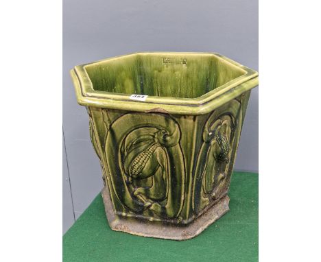 A W C GIBSON GREEN GLAZED STONEWARE PLANTER, THE HEXAGONAL SIDES MOULDED IN RELIEF WITH FRUITING PLANTS.   H 37cms.