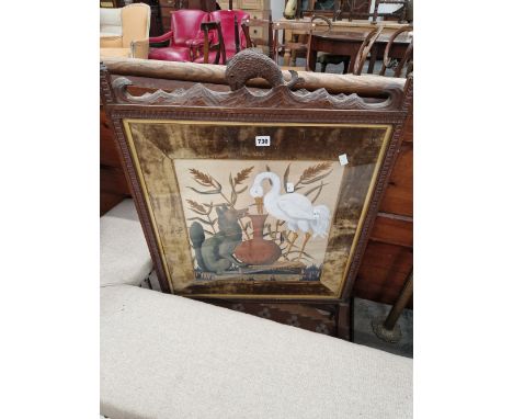 AN OAK FIRESCREEN CRESTED BY A CARVED DOLPHIN HANDLE AND DATED 1-5-95, THE GLAZED FRONT OVER AN OLIVE VELVET MOUNT ENCLOSING 