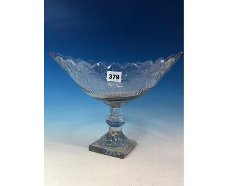AN IRISH NAVETTE SHAPED BOWL, POSSIBLY CORK, STANDING ON A MOULDED SQUARE LEMON SQUEEZER FOOT.   W 33cms.