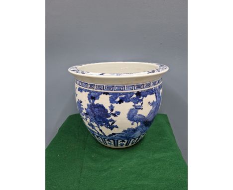 A CHINESE BLUE AND WHITE PLANTER PAINTED WITH BIRDS, PEONIES AND ROCKS.   Dia. 37.5cms.