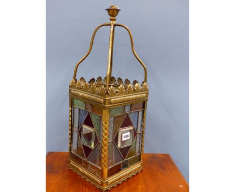 A LATE VICTORIAN BRASS FRAMED LEADED GLASS LANTERN OF SQUARE SECTION WITH FOUR BRASS ARMS MEETING A BAND OF SHELL SHAPES AT T