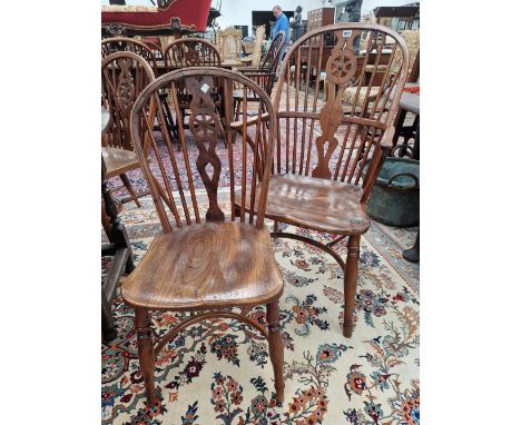 A SET OF SIX SIMILAR ANTIQUE YEW WOOD WINDSOR CHAIRS INCLUDING TWO WITH ARMS, EACH OF THE SADDLE SEATS ABOVE CRINOLINE STRETC