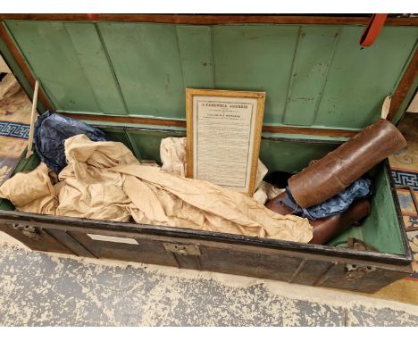 AN OFFICERS TIN TRUNK CONTAINING: TWO PAIRS OF LEATHER PUTTEES, TWO PAIRS OF SPURS, A BELT, A MOSQUITO NET, A FRAMED FAREWELL