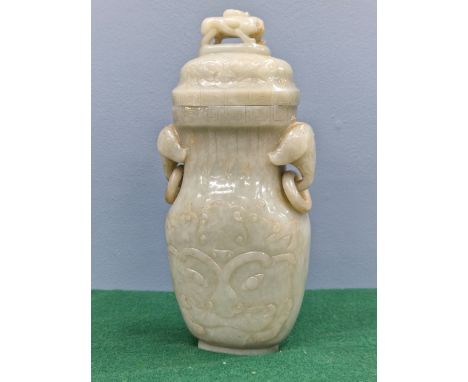 A CHINESE NEPHRITE JADE FLATTENED BALUSTER VASE AND COVER CARVED IN RELIEF WITH DAODIEH, THE ELEPHANT MASK AND RING HANDLES B