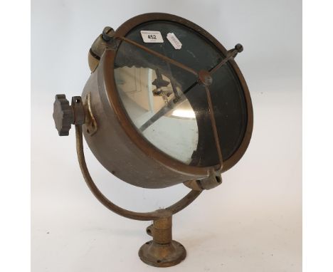 A spotlight, in a brass case, mounted in a frame, probably theatre related, 28.5 cm diameterCould also be a marine lamp ora f