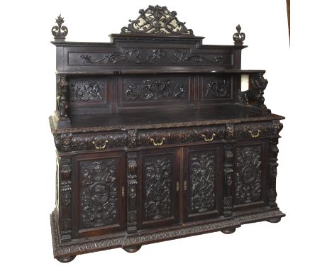 A late 19th century Italian breakfront walnut cabinet, carved in hide relief figures, mythical beasts, flowers and foliage, t