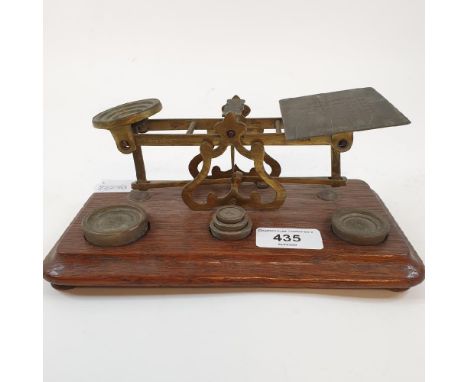 A set of late Victorian brass and oak postal scales, stamped S S Mordan and Co, £1 with engraved post, the base fitted with f