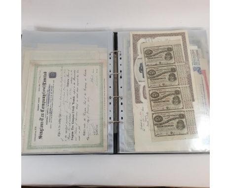 Assorted share certificates, bonds and other ephemera, in an album 