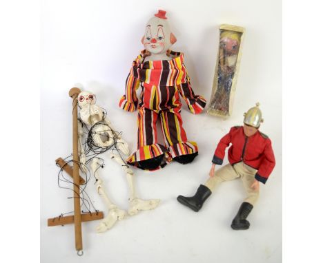 A Palitoy Action Man figure, two Pelham puppets and a ceramic headed clown puppet. (4)