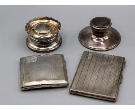 A pair of sterling silver cigarette cases and two glass lined inkwells. The first case, engraved with the initials CEK, is ma