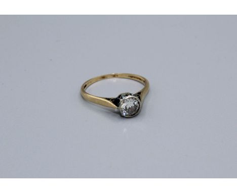A diamond solitaire ring featuring a round brilliant cut diamond of an estimated 0.65 carat. The diamond is held in a bezel s