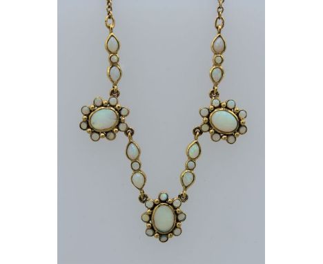 A "9ct" stamped Edwardian style opal necklace. Featuring three cluster panels of opals interspersed with opal set links. With