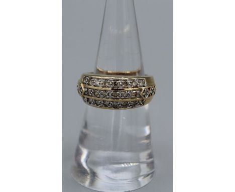 A diamond set 9ct gold ring. Set with 26 round brilliant cut champagne diamonds with an estimated total of 0.76 carats of dia