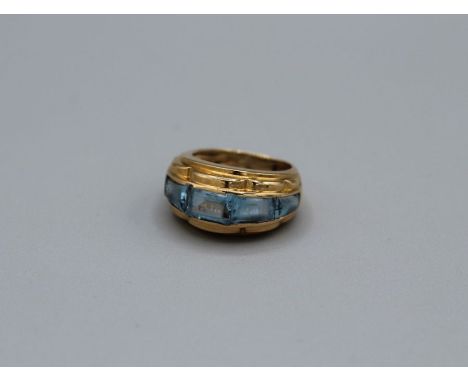 A Vintage signed Tiffany &amp; Co Topaz dress ring. Featuring channel set, calibre cut blue Topaz ring in yellow metal. Stamp